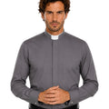 Man wearing a gray clerical shirt with a white collar on a white background