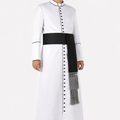 Man wearing a white traditional outfit with a black sash on a white background