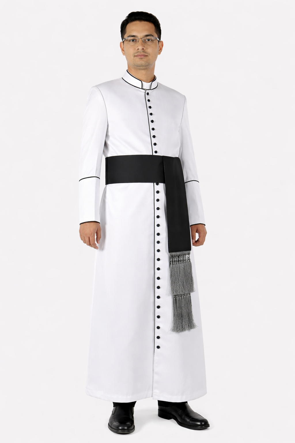 Man wearing a white traditional outfit with a black sash on a white background