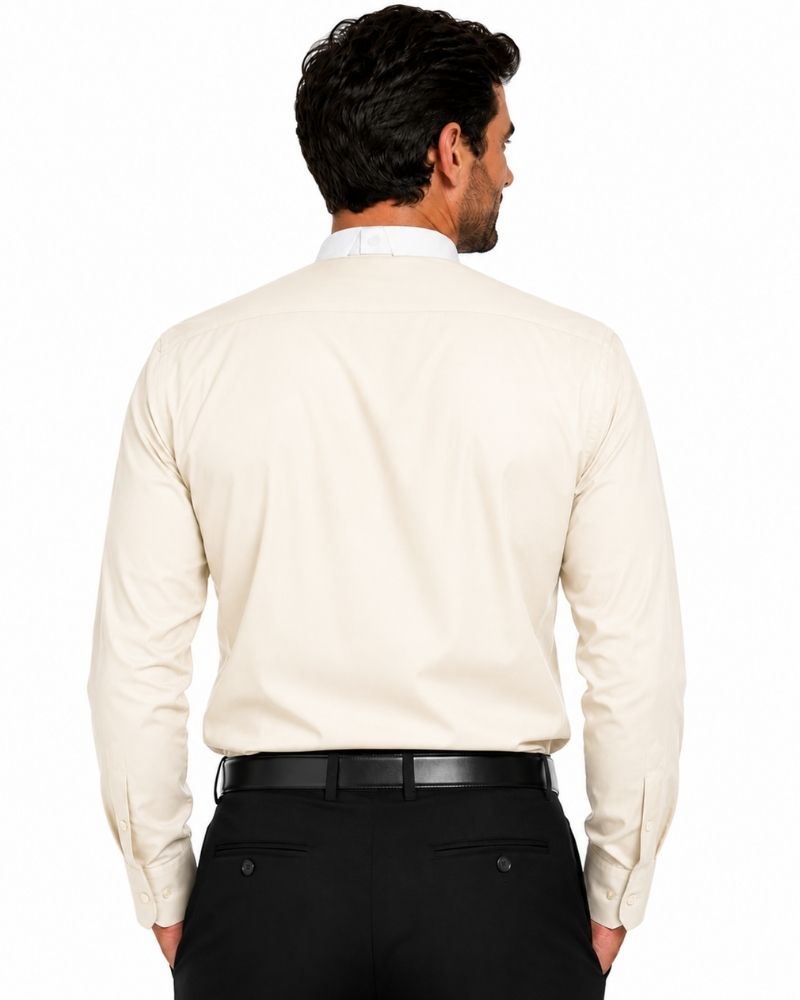 A man viewed from the back wearing a light cream-colored long-sleeve clerical shirt and black trousers, against a plain white background.