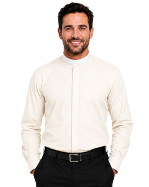 A smiling man wearing a cream-colored long-sleeve clerical shirt with a high mock neck, paired with black trousers and a black belt, against a plain white background.