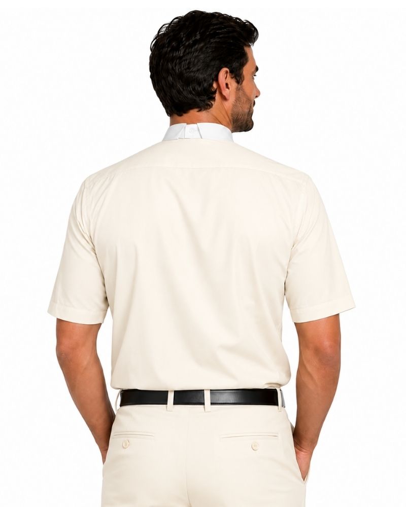 A man shown from the back wearing a short-sleeve cream-colored clerical shirt, cream trousers, and a black belt, against a plain white background.