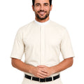 A smiling man wearing a cream-colored short-sleeve clerical shirt with a mock neck and front button placket, paired with matching trousers and a black belt, against a plain white background.