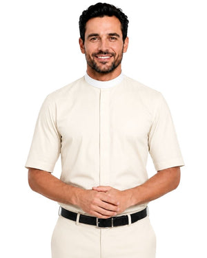 A smiling man wearing a cream-colored short-sleeve clerical shirt with a mock neck and front button placket, paired with matching trousers and a black belt, against a plain white background.
