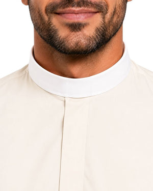 Close-up of a man wearing a cream-colored traditional clerical shirt with a high white collar, against a plain white background.