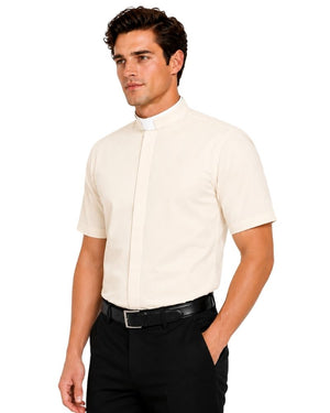 A man wearing a short-sleeve cream-colored clerical shirt with a white collar, paired with black trousers and a black belt, photographed against a solid white background.