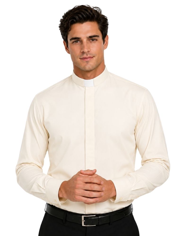 A man wearing a cream-colored long-sleeve clerical shirt with a high mock neck and white collar, paired with black trousers and a black belt, against a plain white background.