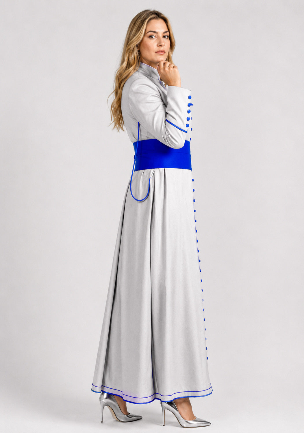 Woman wearing a gray robe with blue accents on a white background
