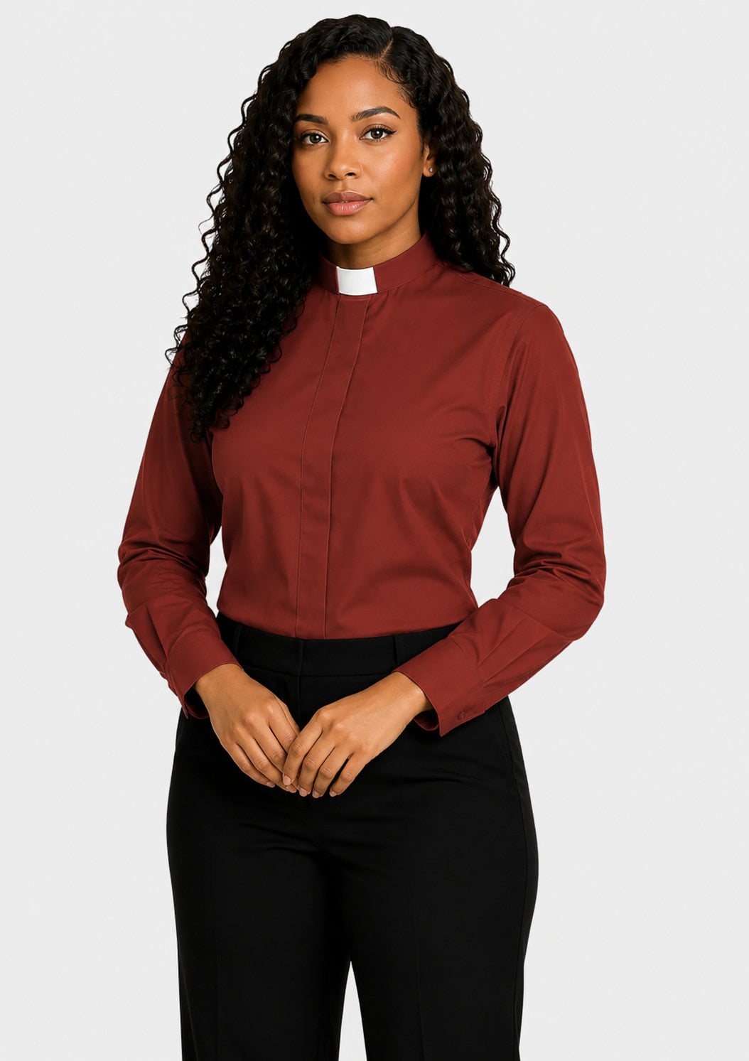 Woman wearing a burgundy shirt with a white collar against a plain background