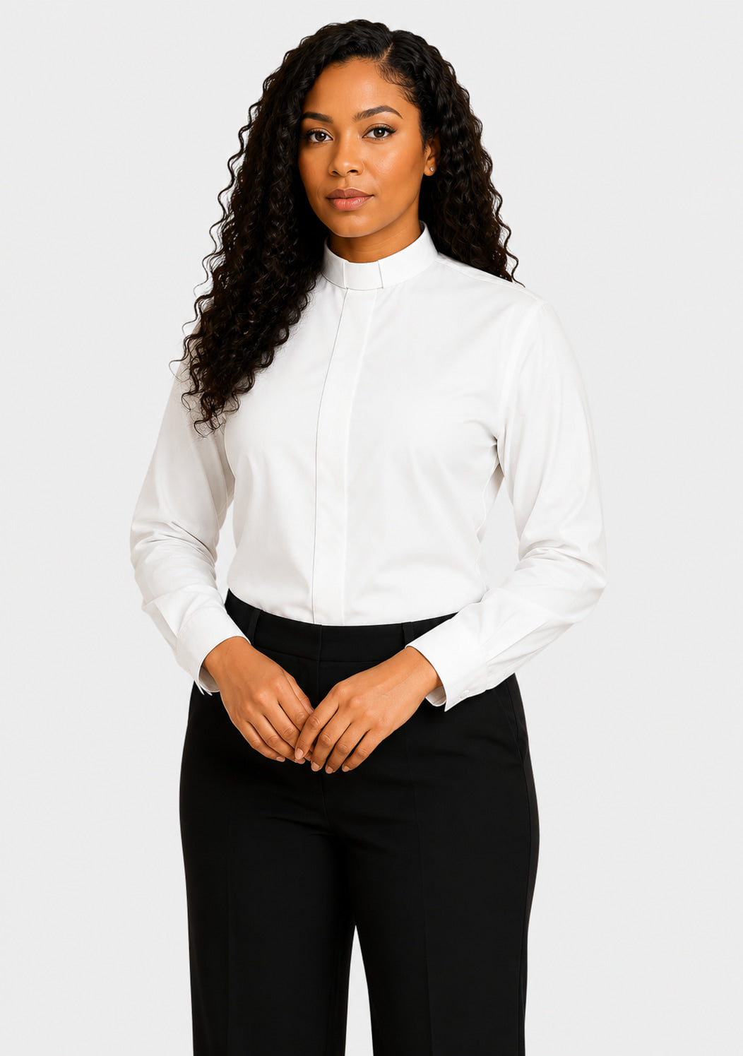 Woman wearing a white blouse and black pants on a plain background