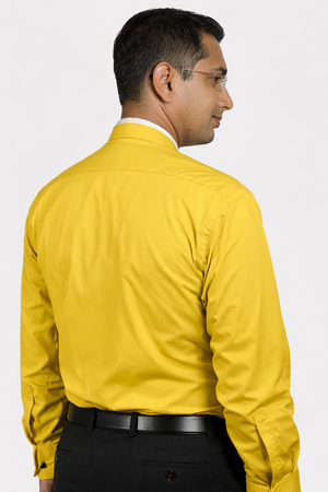 Man wearing a yellow dress shirt on a white background