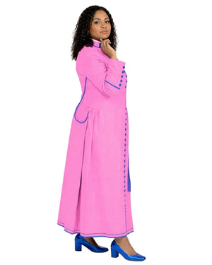 A woman modeling a bright pink long dress with blue trim and blue high heels against a plain white background.