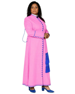 A woman modeling a long pink cassock with blue trim, blue tassel details, and blue shoes against a plain white background.