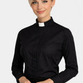 Woman wearing a black clerical shirt with a white collar on a white background