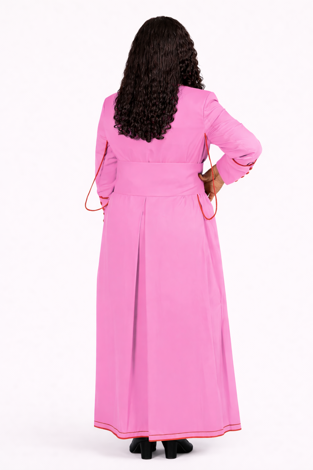 Person wearing a pink dress with long sleeves on a white background