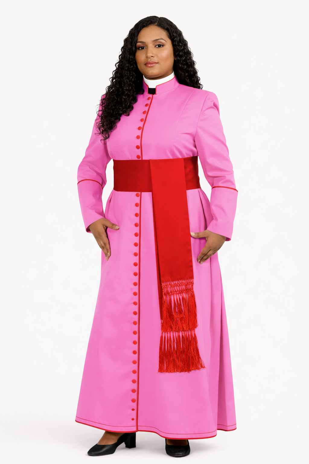 Woman wearing a pink outfit with a red belt and scarf on a white background