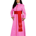 A woman modeling a pink priestly robe costume with a red waist sash and a matching red stole with fringe, set against a plain white background.