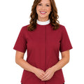 Woman wearing a maroon clerical shirt with a white collar against a white background