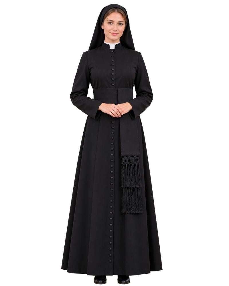 A woman modeling a Black Clergy Cassock with a white collar, black front buttons, and a matching black sash with fringe, photographed against a plain white background.