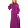 A woman modeling a long magenta-purple clerical robe with a high collar, front button closure, and a white clerical collar, set against a plain white background.