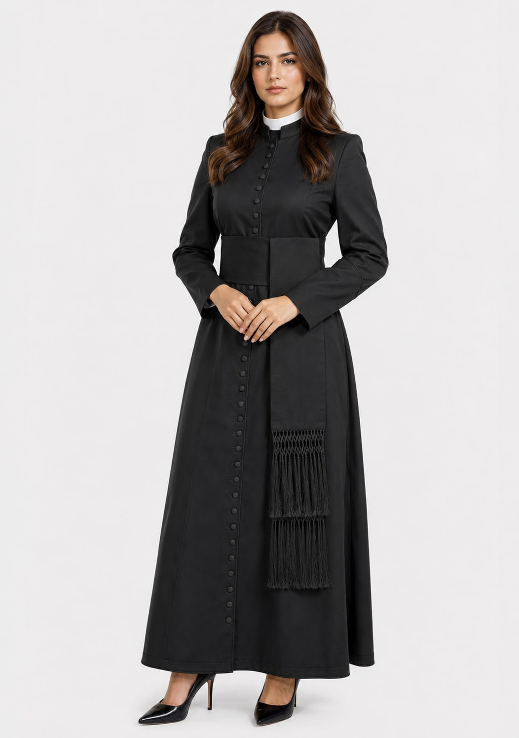 Woman wearing a long black coat with a sash on a white background