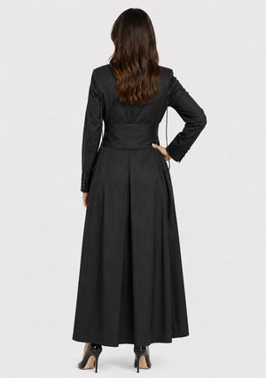 Woman wearing a black long coat on a white background