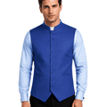 A man wearing a royal blue waistcoat vest over a light blue dress shirt, standing against a white background.
