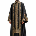 Man wearing a black robe with gold embroidery on a white background