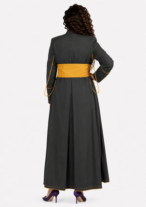Woman wearing a long dark gray robe with yellow accents on a white background