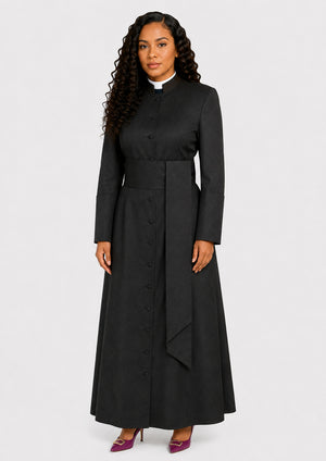 Woman wearing a black long cassock with a white collar on a white background
