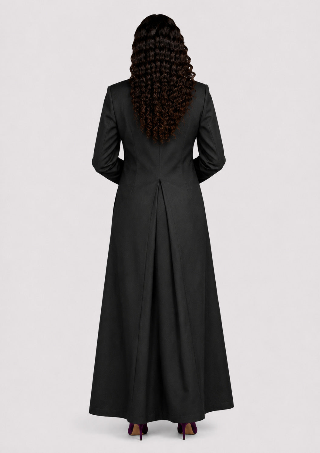 Person wearing a black cassock from behind on a white background