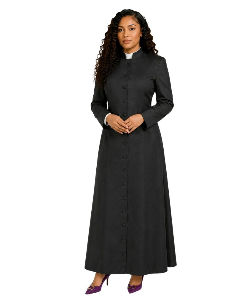 A woman modeling a long black cassock with a high collar, front button closure, and long sleeves, paired with purple heels against a plain white background.