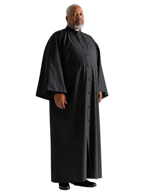 A man modeling a long black clerical robe with a high collar, standing against a plain white background.