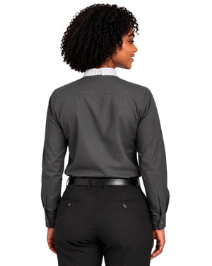 A woman shown from the back wearing a dark charcoal gray long-sleeve clerical shirt tucked into black dress pants with a black belt, against a plain white background.