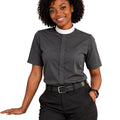 A woman modeling a dark gray short-sleeve clerical shirt with a white collar, paired with black trousers and a black belt, against a plain white background.