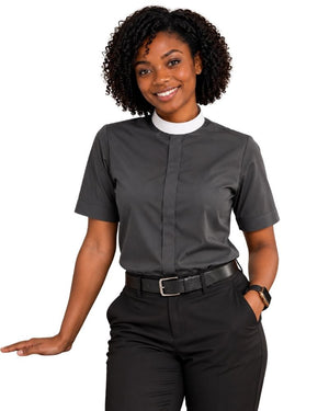 A woman modeling a dark gray short-sleeve clerical shirt with a white collar, paired with black trousers and a black belt, against a plain white background.