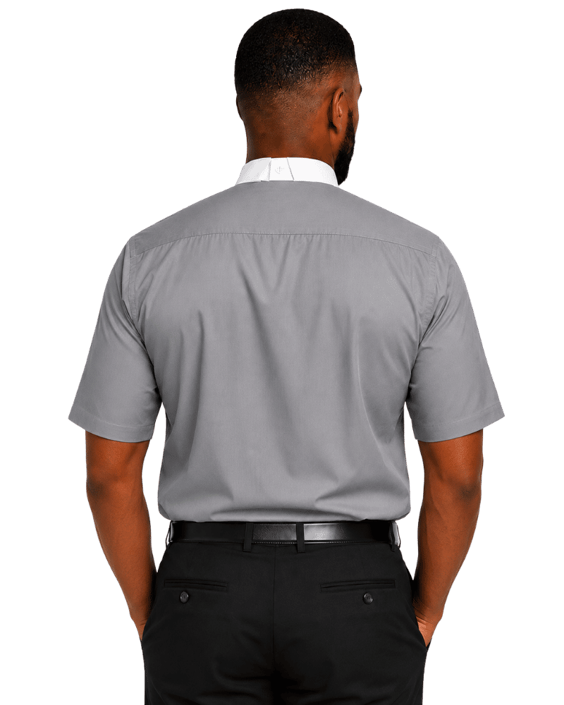 A man viewed from the back wearing a light gray short-sleeve clerical shirt, black trousers, and a black belt against a plain white background.