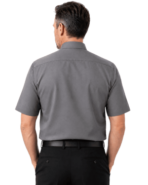 A man viewed from the back wearing a short-sleeve gray clerical  shirt and black trousers, isolated on a white background.