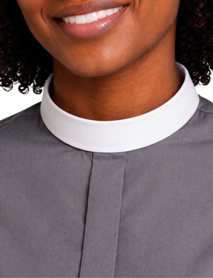 Close-up of a woman wearing a gray clerical shirt with a contrasting white high collar, cropped from the mouth to the chest.