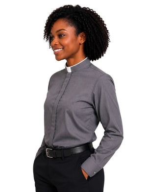 A woman wearing a long-sleeve gray clerical shirt with a white collar, paired with black trousers and a black belt, shown against a plain white background.