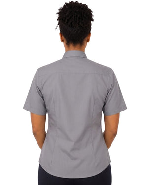 A woman viewed from the back wearing a short-sleeve gray clerical shirt and dark pants, against a plain white background.