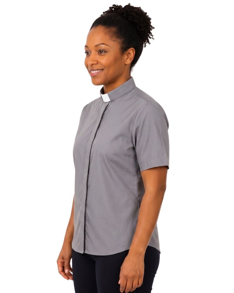 A woman modeling a short-sleeve gray clerical shirt with a white collar, shown in profile against a plain white background.