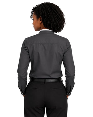 A woman viewed from the back wearing a dark charcoal gray long-sleeve clerical shirt tucked into black trousers, against a plain white background.
