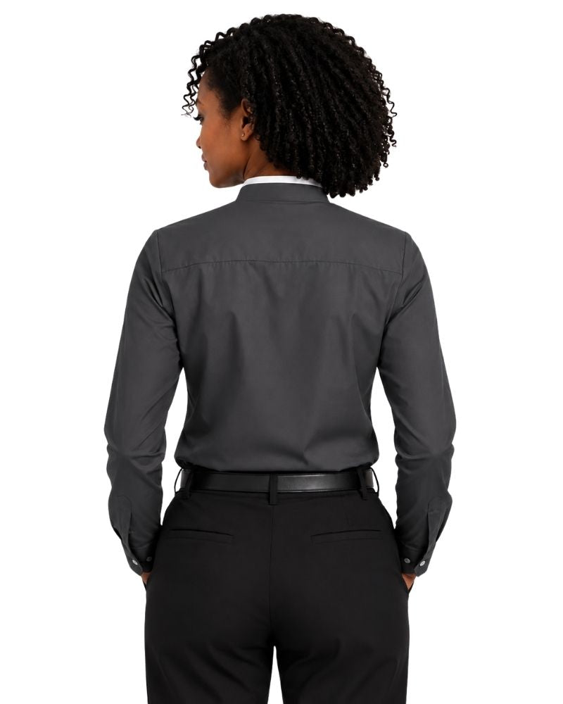 A woman viewed from the back wearing a dark charcoal gray long-sleeve clerical shirt tucked into black trousers, against a plain white background.