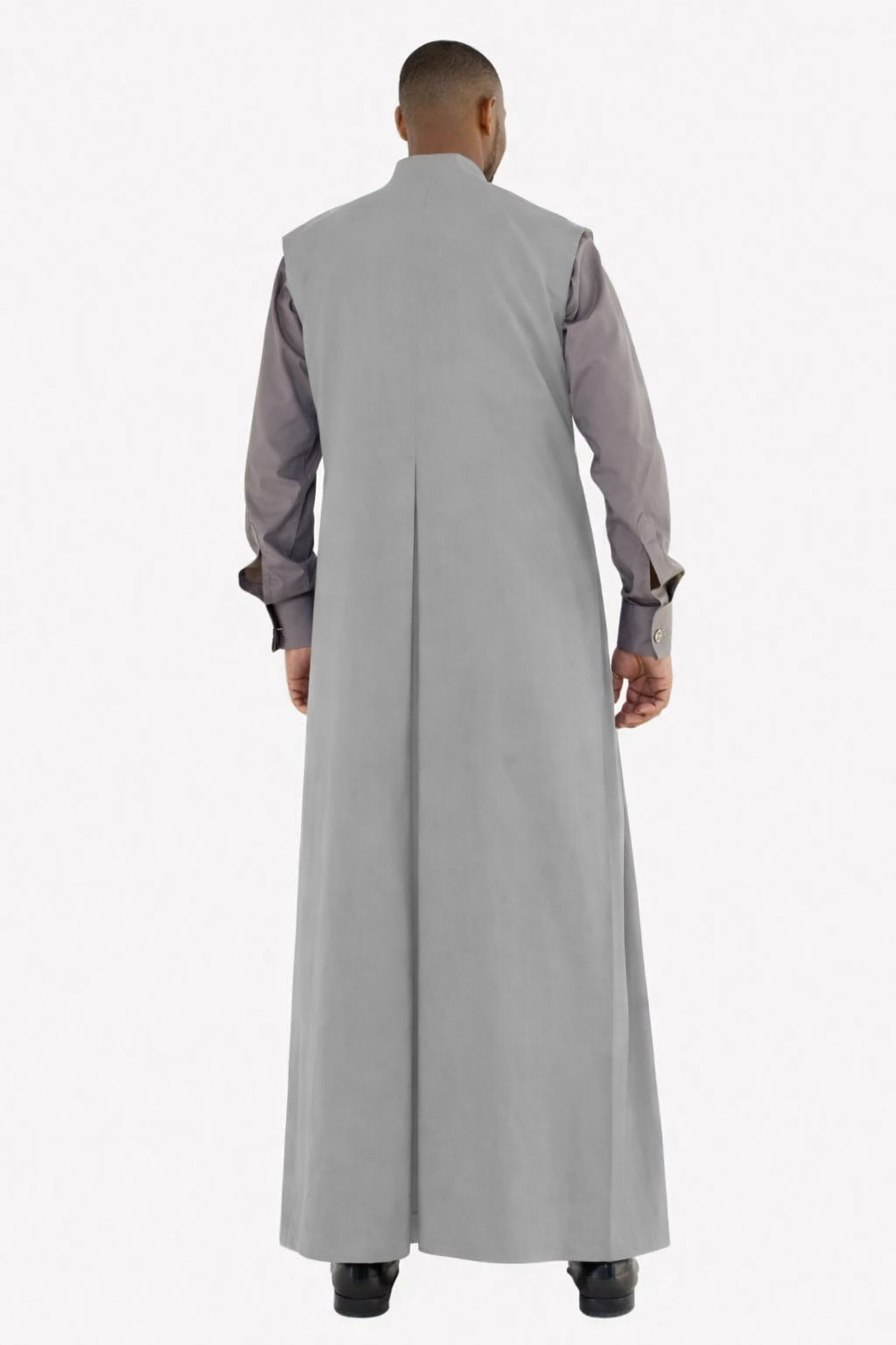 Man wearing a long gray robe with a white background