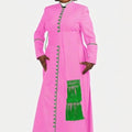 Woman wearing a pink dress with green accents on a white background