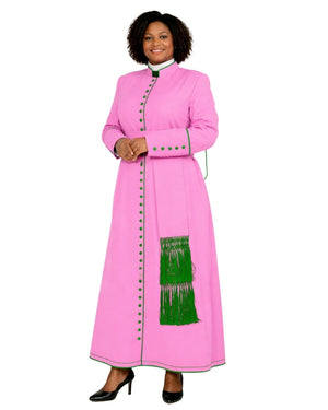 A woman modeling a bright pink clerical cassock with green fringe and green button accents, photographed against a plain white background.
