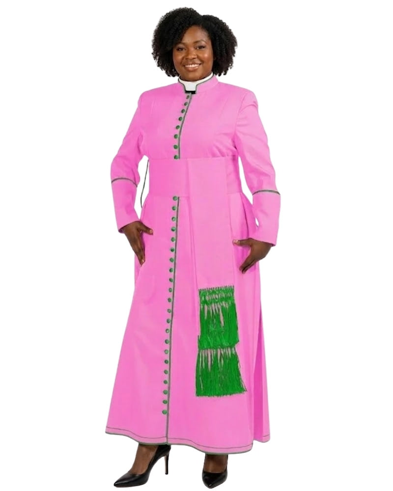 A woman modeling a bright pink long-sleeve cassock with green trim, decorative green buttons, and a green fringe panel on the front, set against a plain white background.