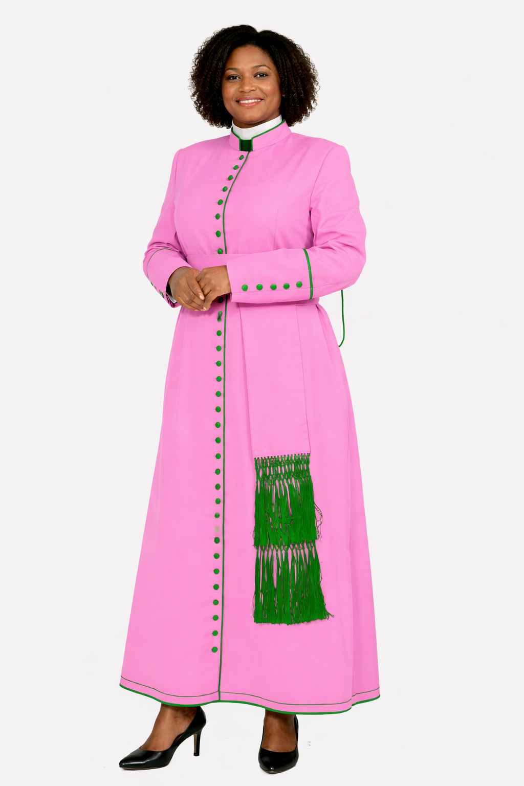 Woman wearing a pink dress with green accents on a white background