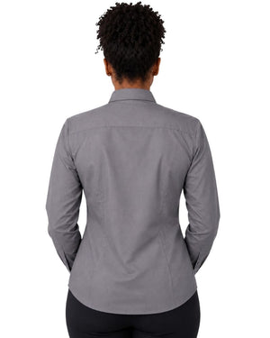 A woman viewed from the back wearing a gray long-sleeve clerical shirt and black pants, set against a plain white background.